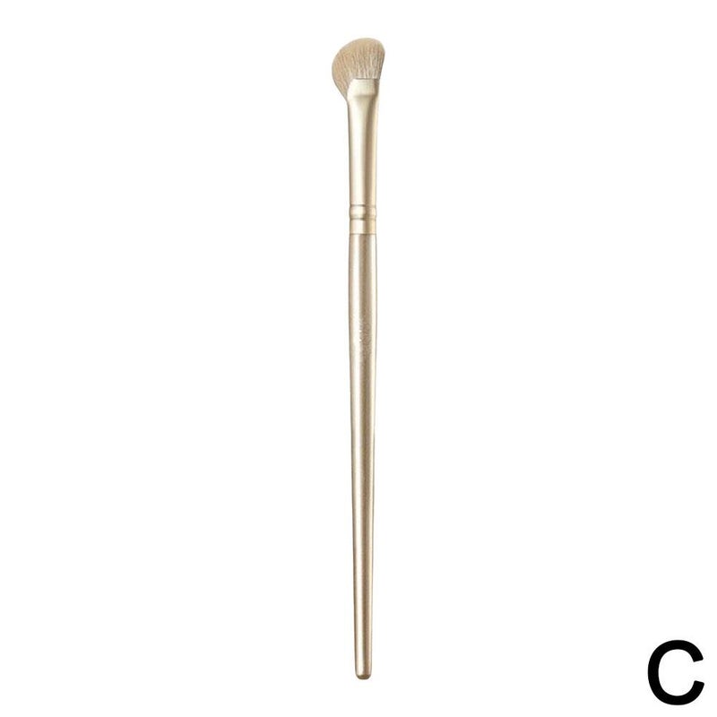 Champagne-colored half-fan-shaped sickle nose shadow brush, angled tip for blending highlighter, contour, and shading. Soft bristles.